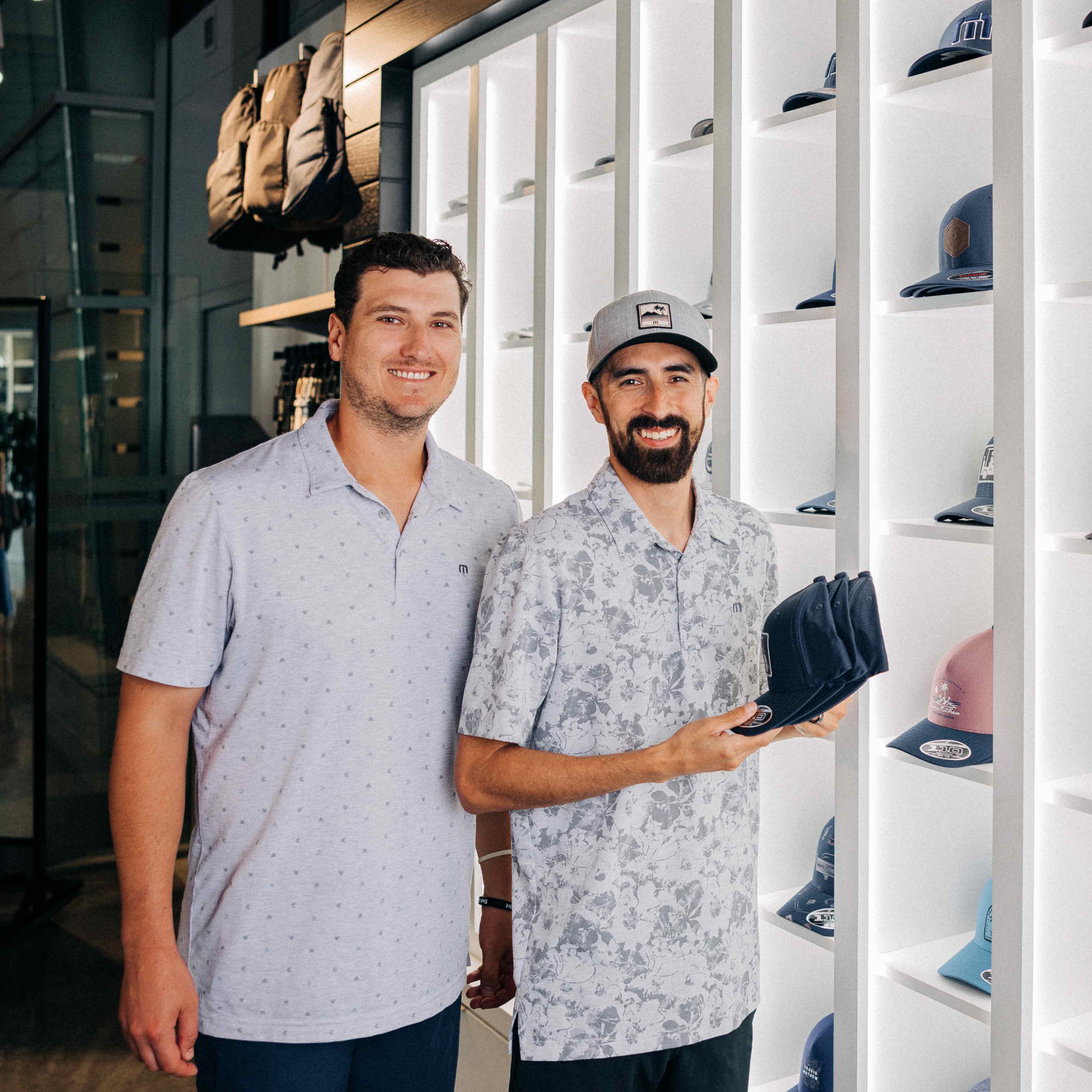 two-men-smiling-with-baseball-caps