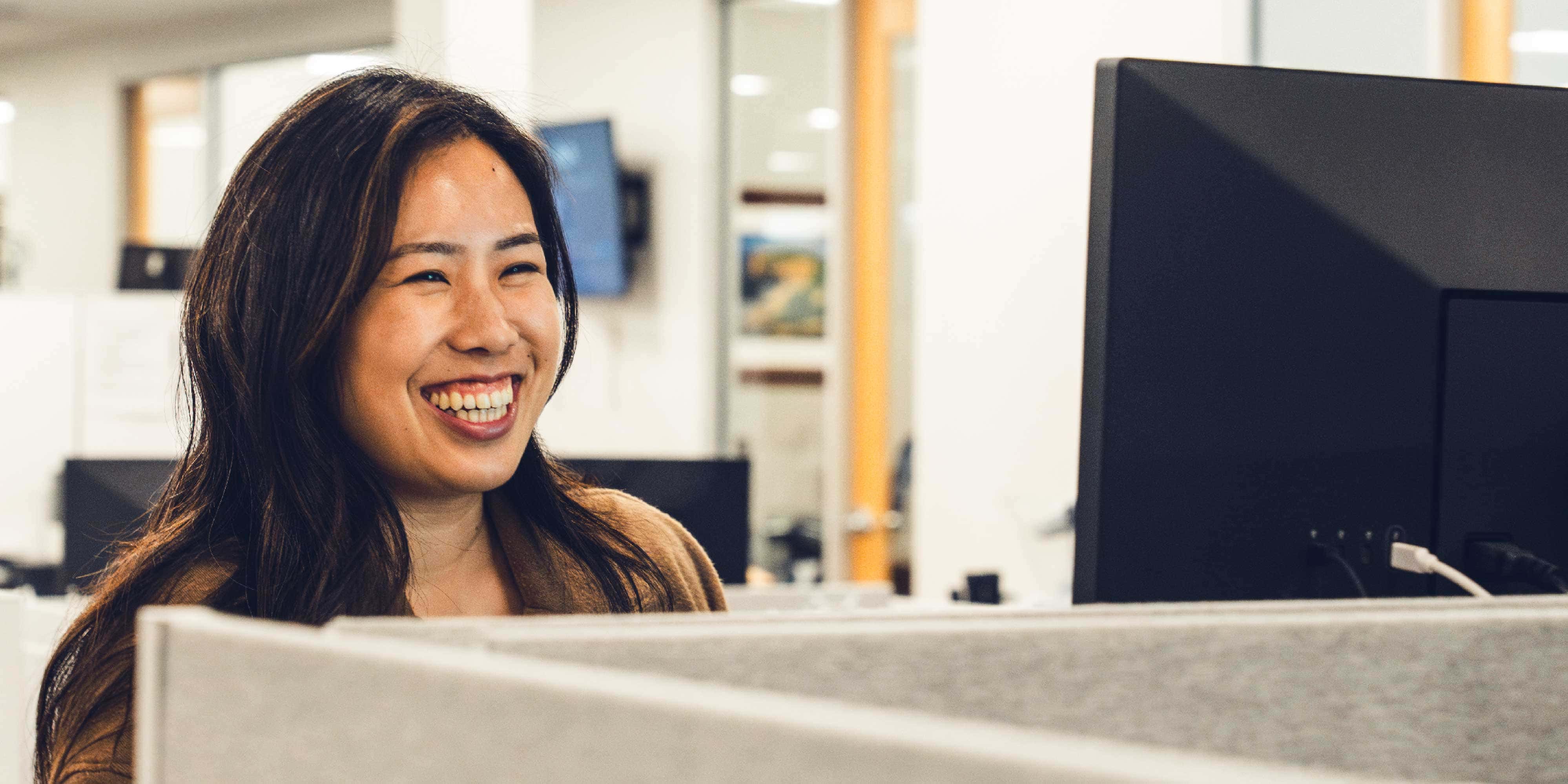 woman smiling at computer